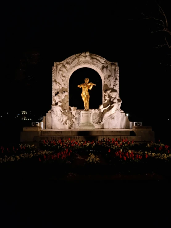 a statue that has a large golden person on it