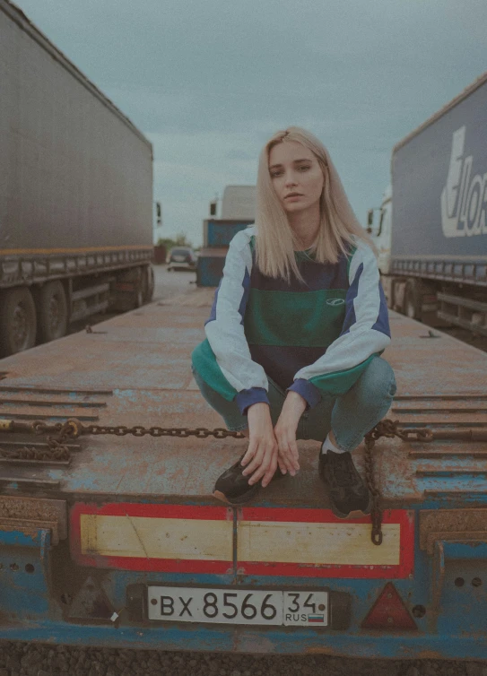 a woman sitting on the back of a truck