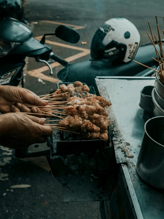 there are many skewers of food on a table