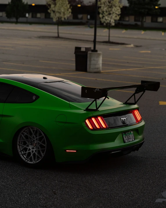 a sports car that is green and parked in a parking lot