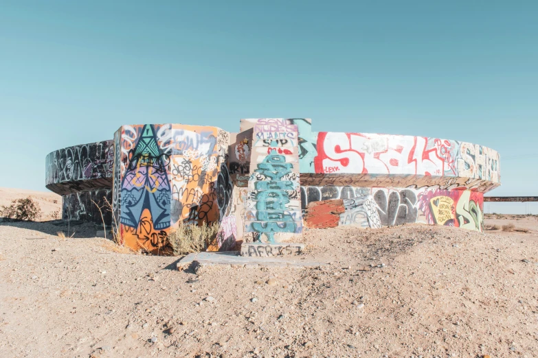 a pile of graffiti sitting on top of a desert