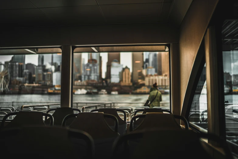 a group of chairs in a room with the city outside the window