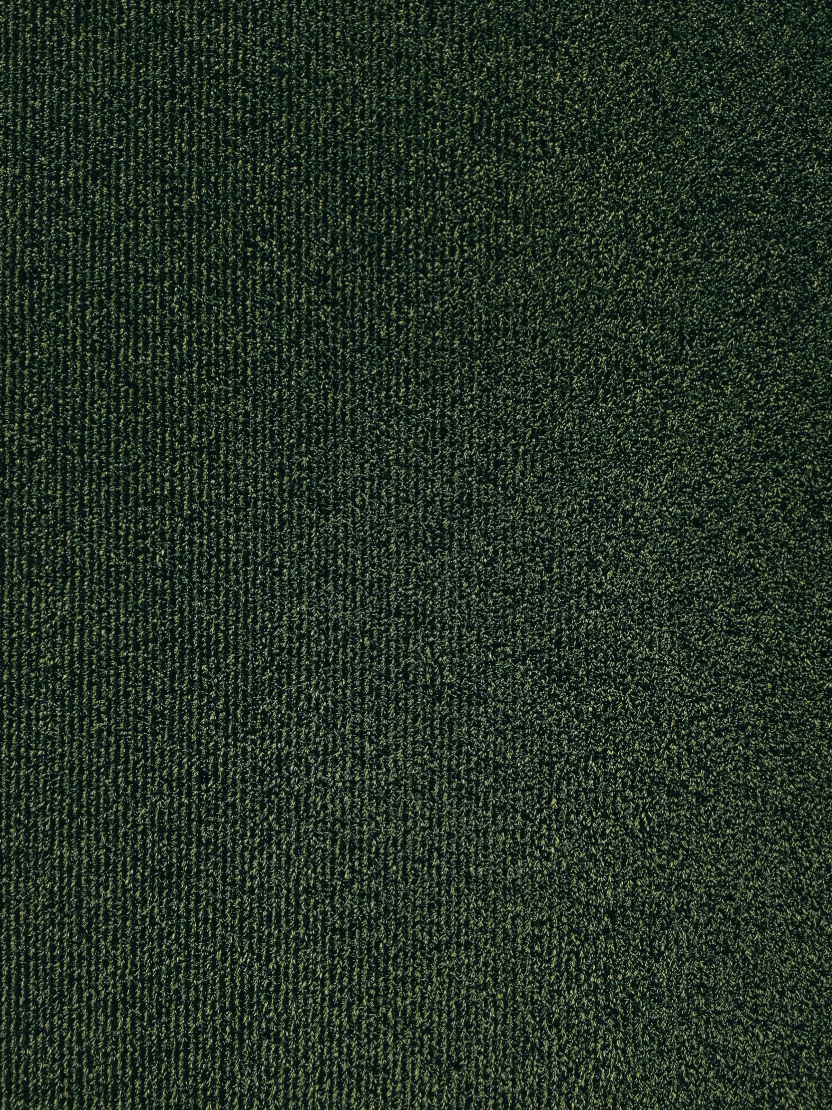 a textured dark green cloth from a blanket