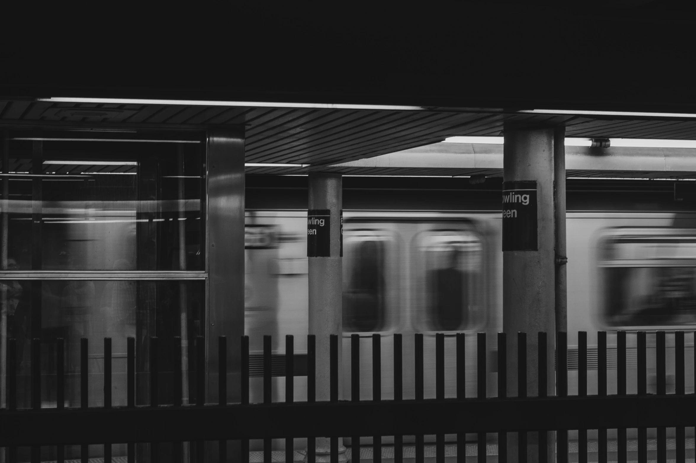 a train passing by with a wood fence around it