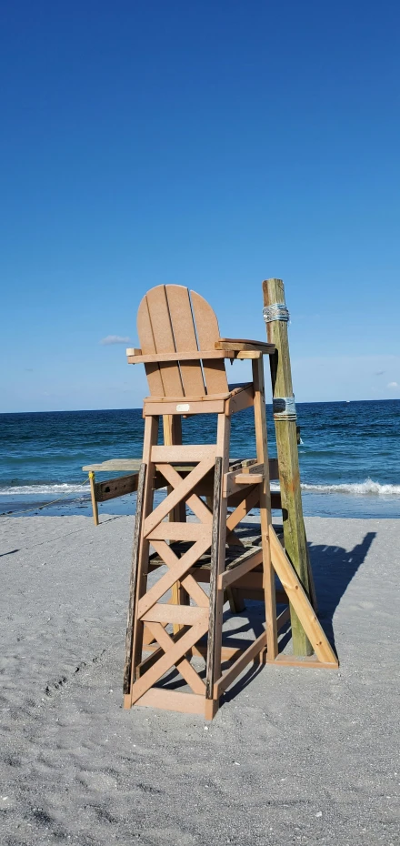 a wooden lifeguard tower with two chairs sitting on top of it