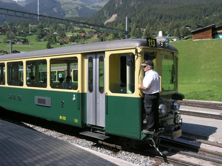 the man in white is standing on top of a train
