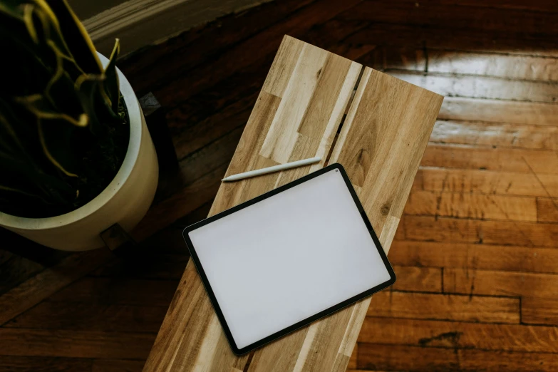 a paper and an easel resting on a wooden table