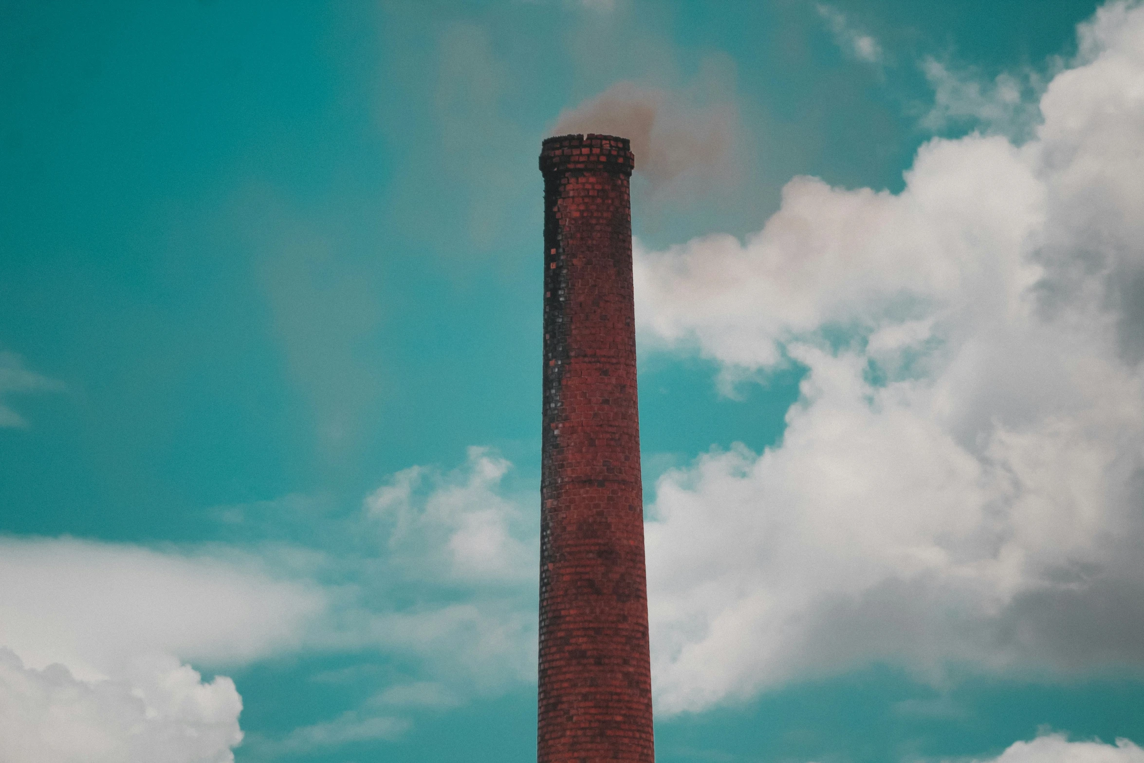 a factory chimney with smoke emits from it