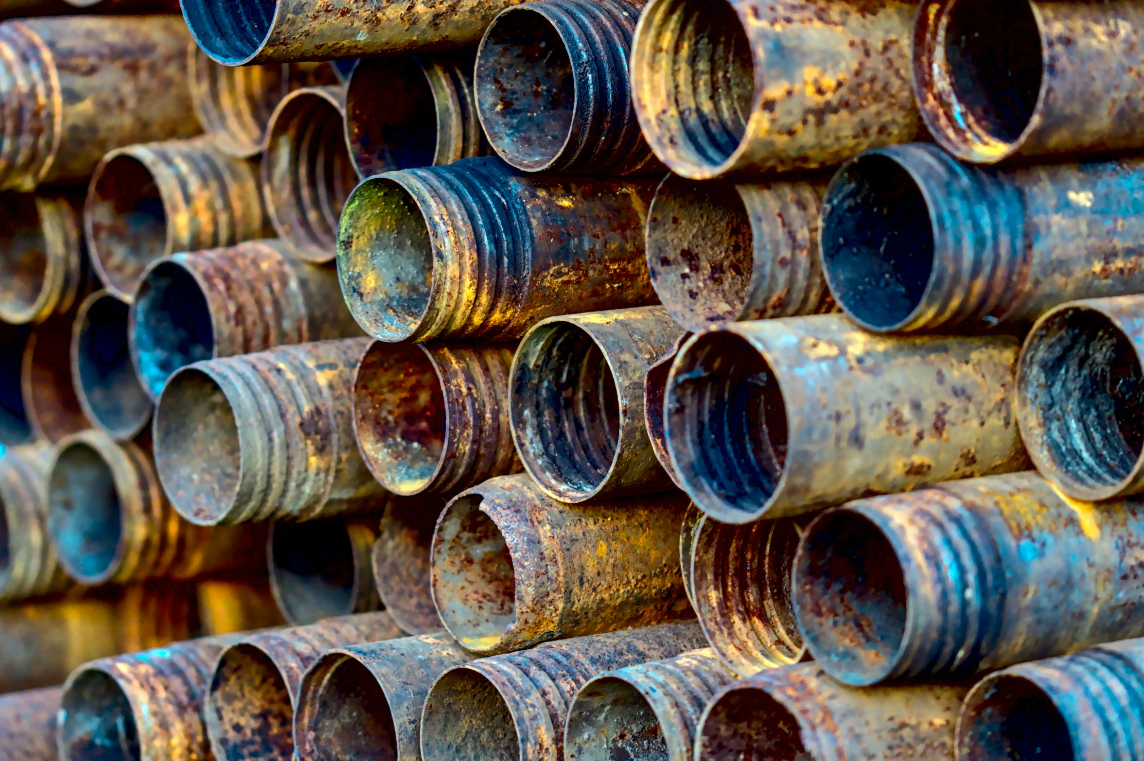 many metal pipes that are stacked together