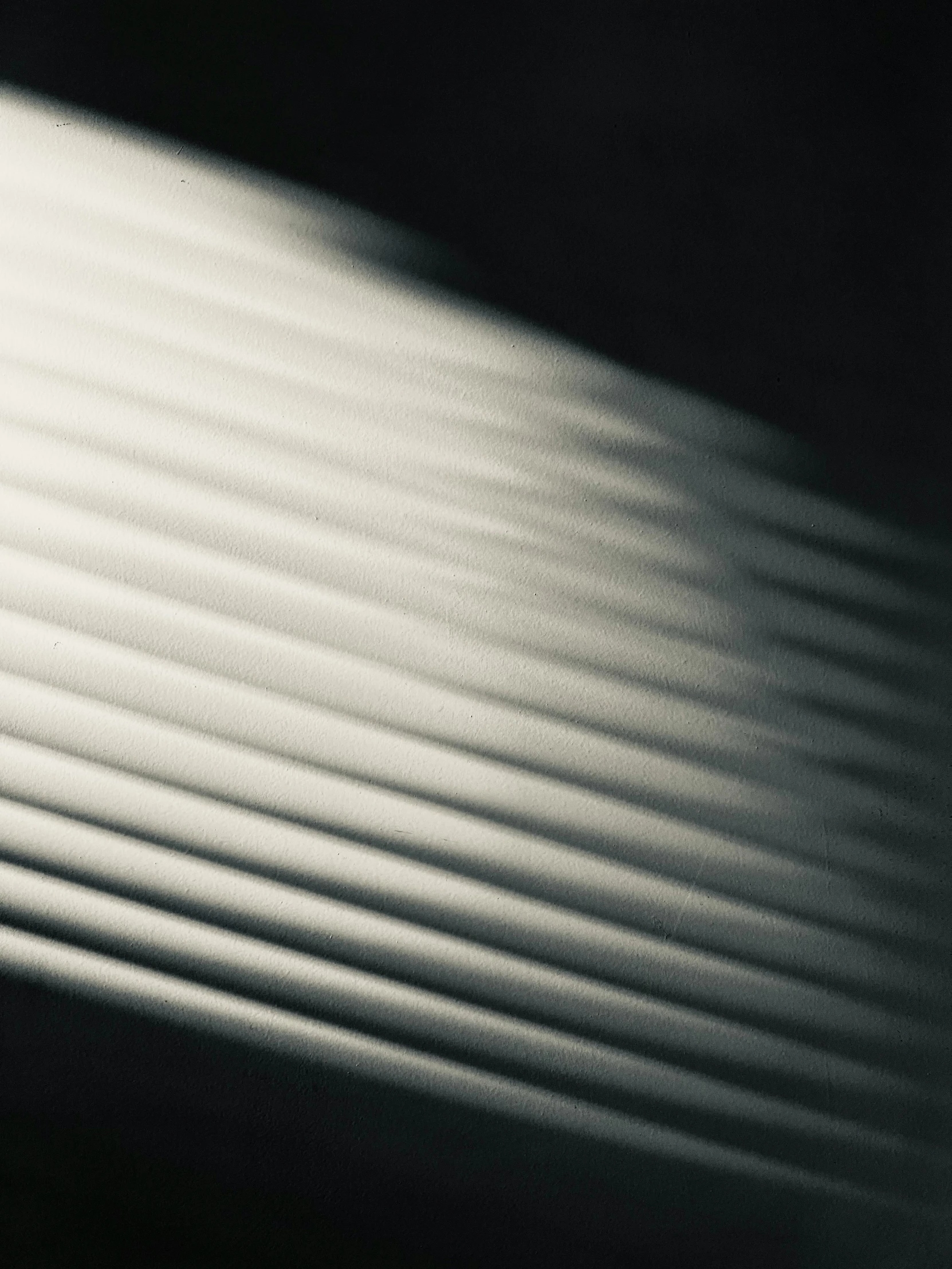 a close up of a surfboard against a white wall