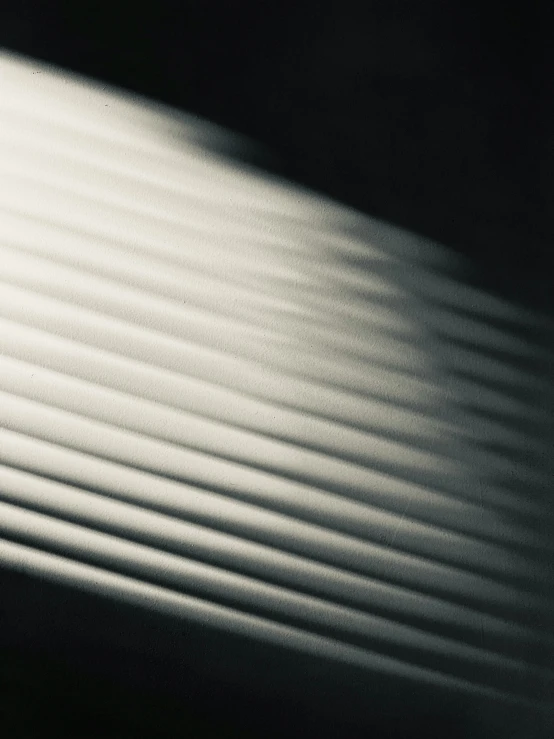 a close up of a surfboard against a white wall