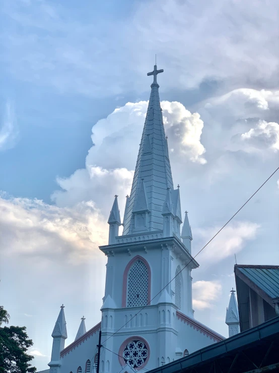 the spire of a church is white and has a clock