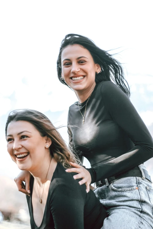 two women in short jeans posing for a picture