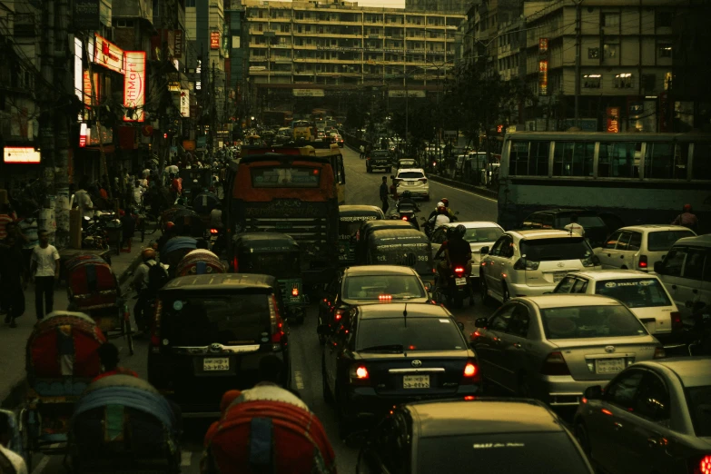 a busy city street filled with traffic next to tall buildings