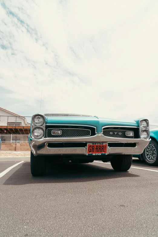 a blue vintage car parked on the street with another blue car