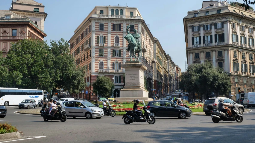 several motorcycles are driving down the city street