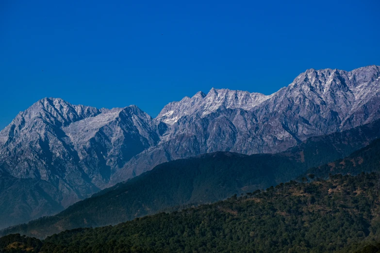 the mountains are covered in snow as seen from a distance