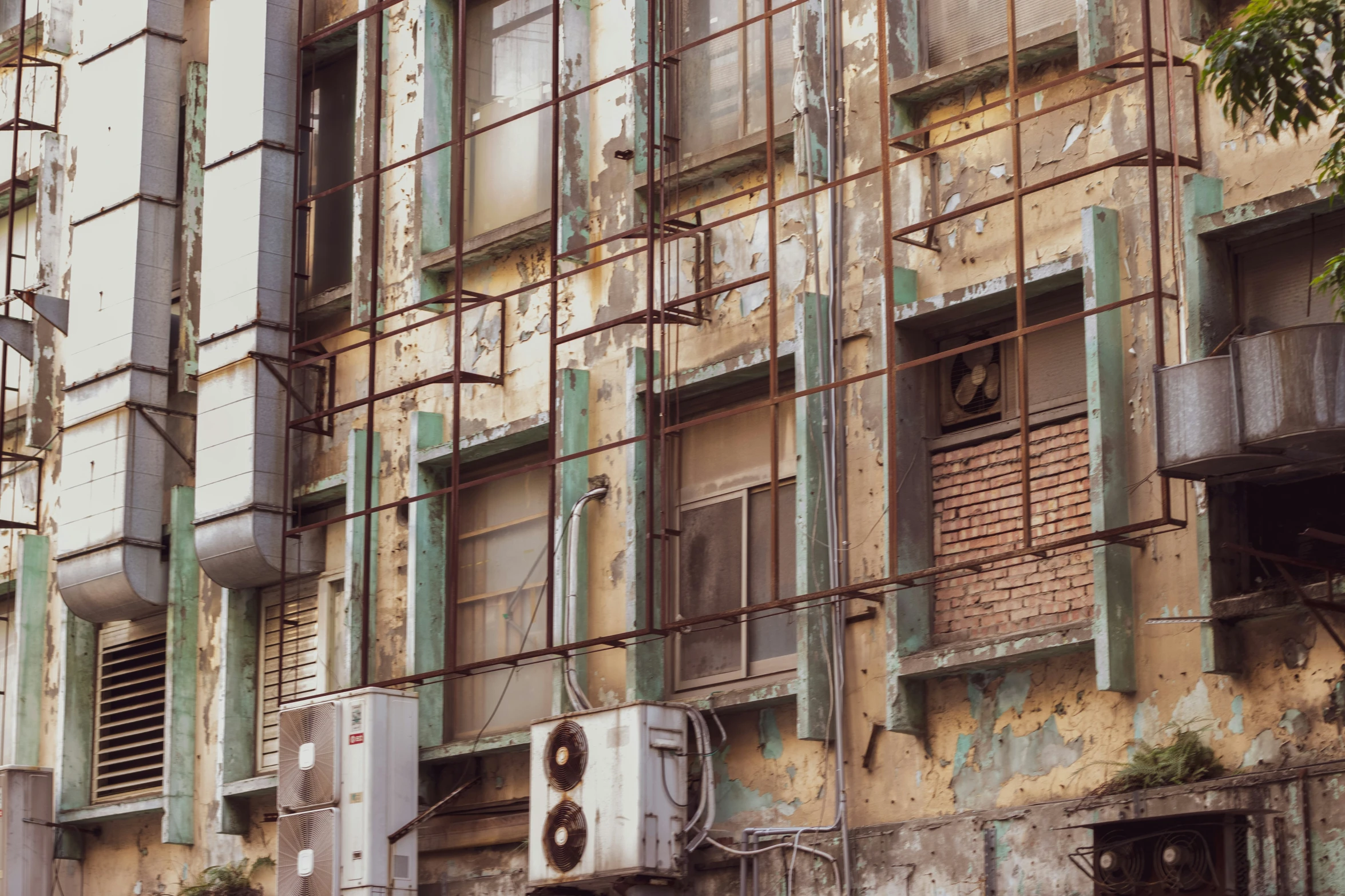 an old run down building with windows and pipes on the sides