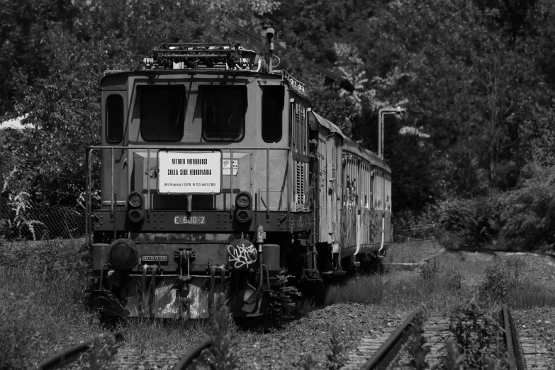 a black and white image of train on tracks