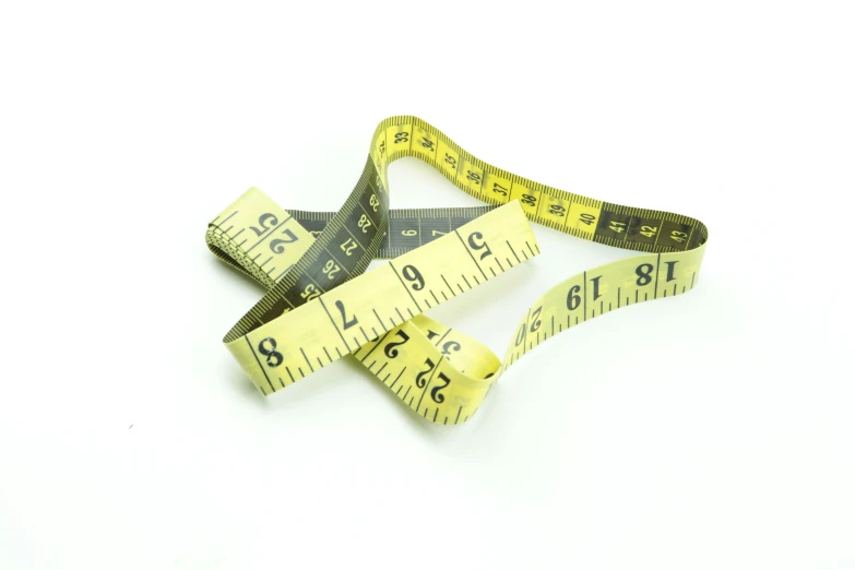 some measuring tape are lying on top of each other