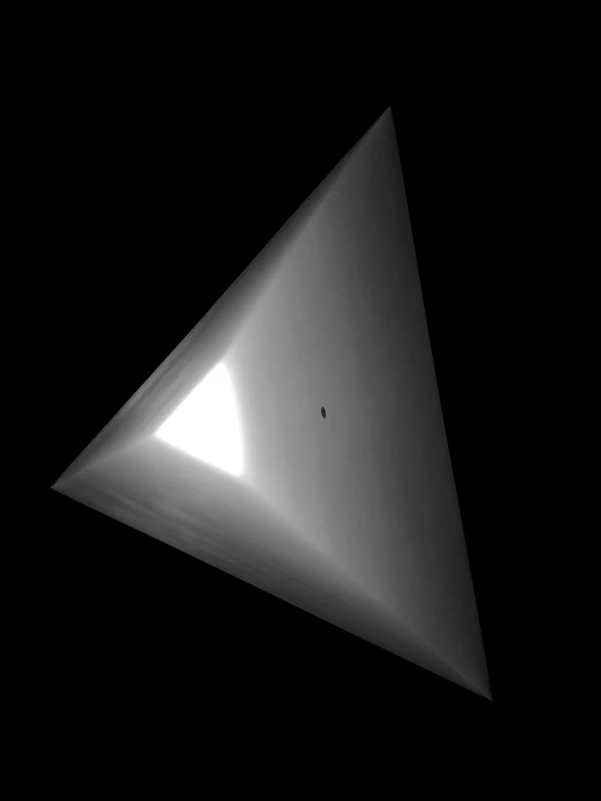 a very shiny metal object is pictured in the dark