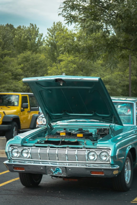 an old station wagon is parked by some trees