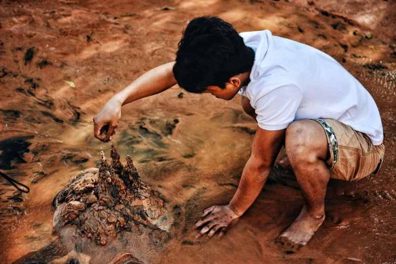 a man placing soing in a jar on the ground