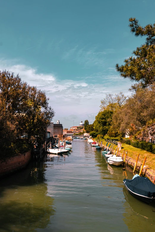 several boats moored on the side of a canal