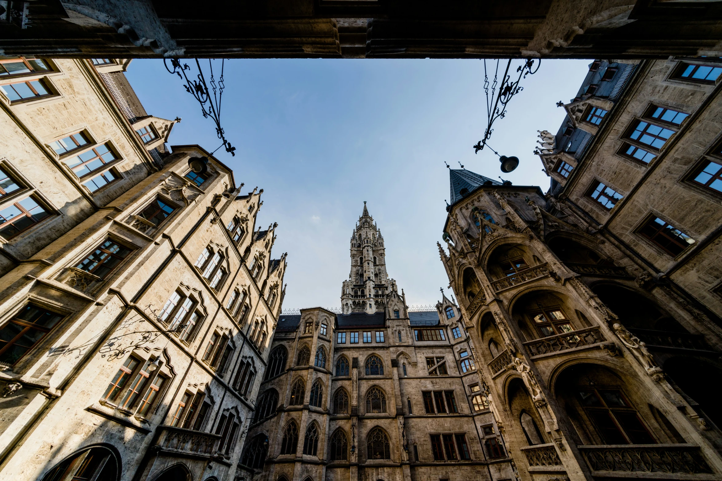 looking up at the tall buildings with one spire