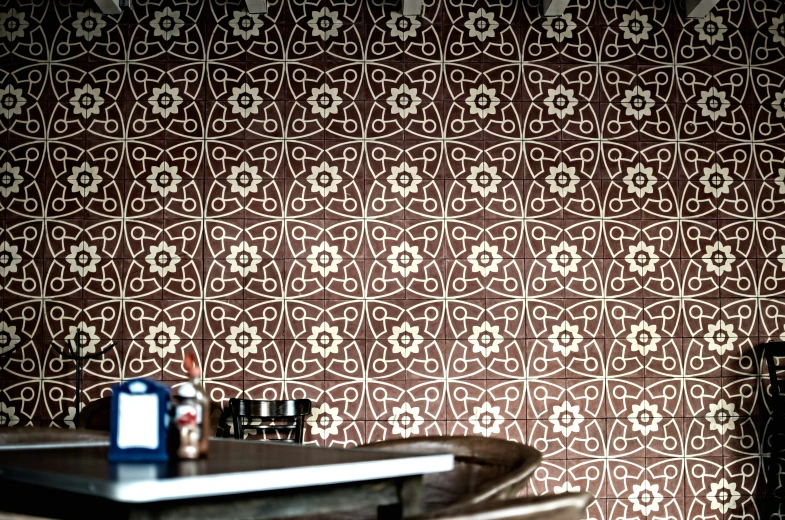 the interior of a restaurant with a brown wallpaper design