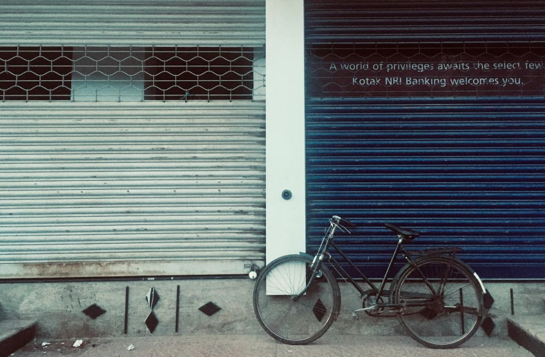 a bike that is parked next to a closed garage door