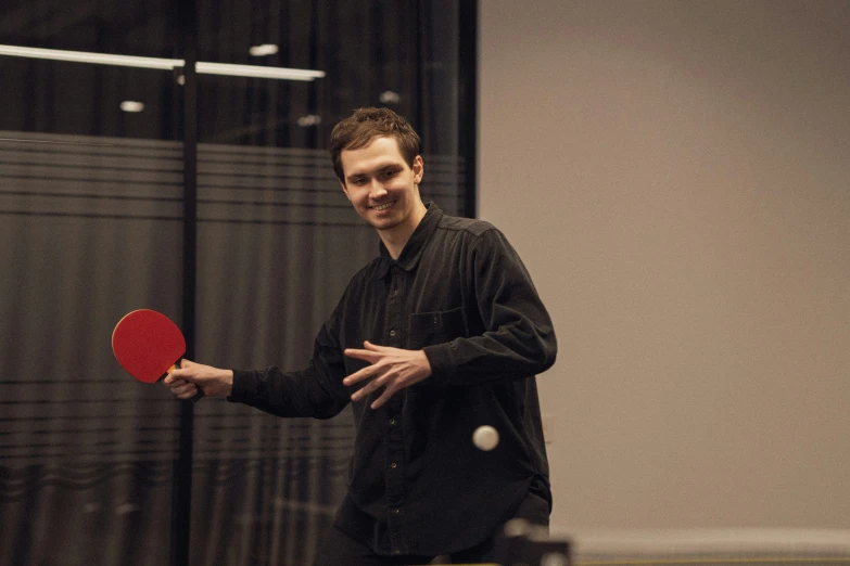 a man with a racket prepares to play ping pong