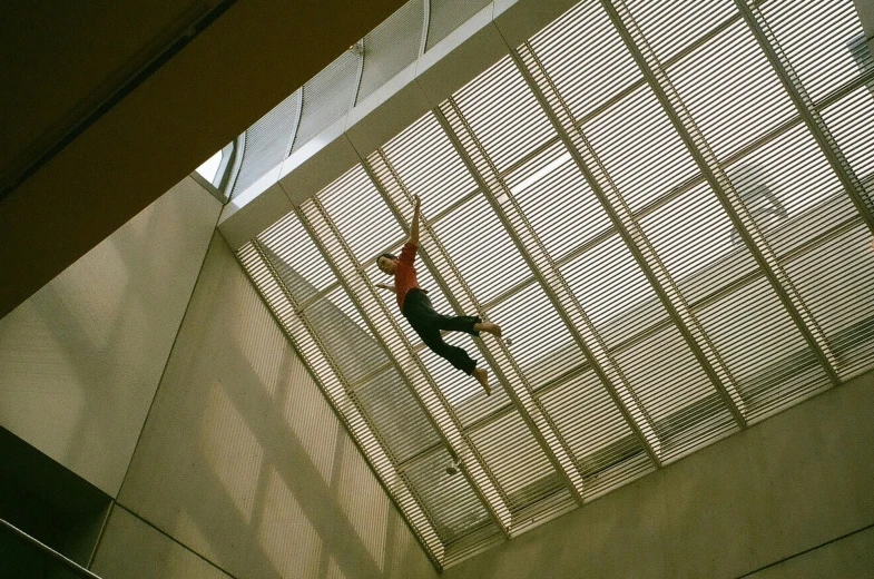 a man riding a skateboard under a roof