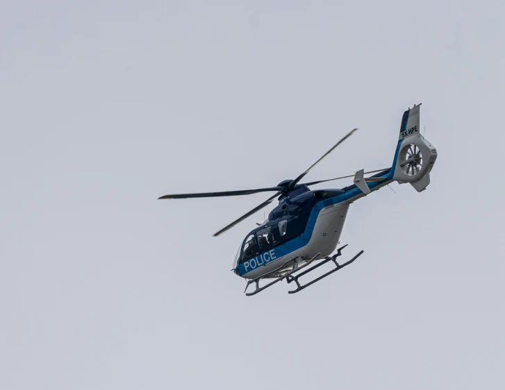 a helicopter flying through the air near another plane