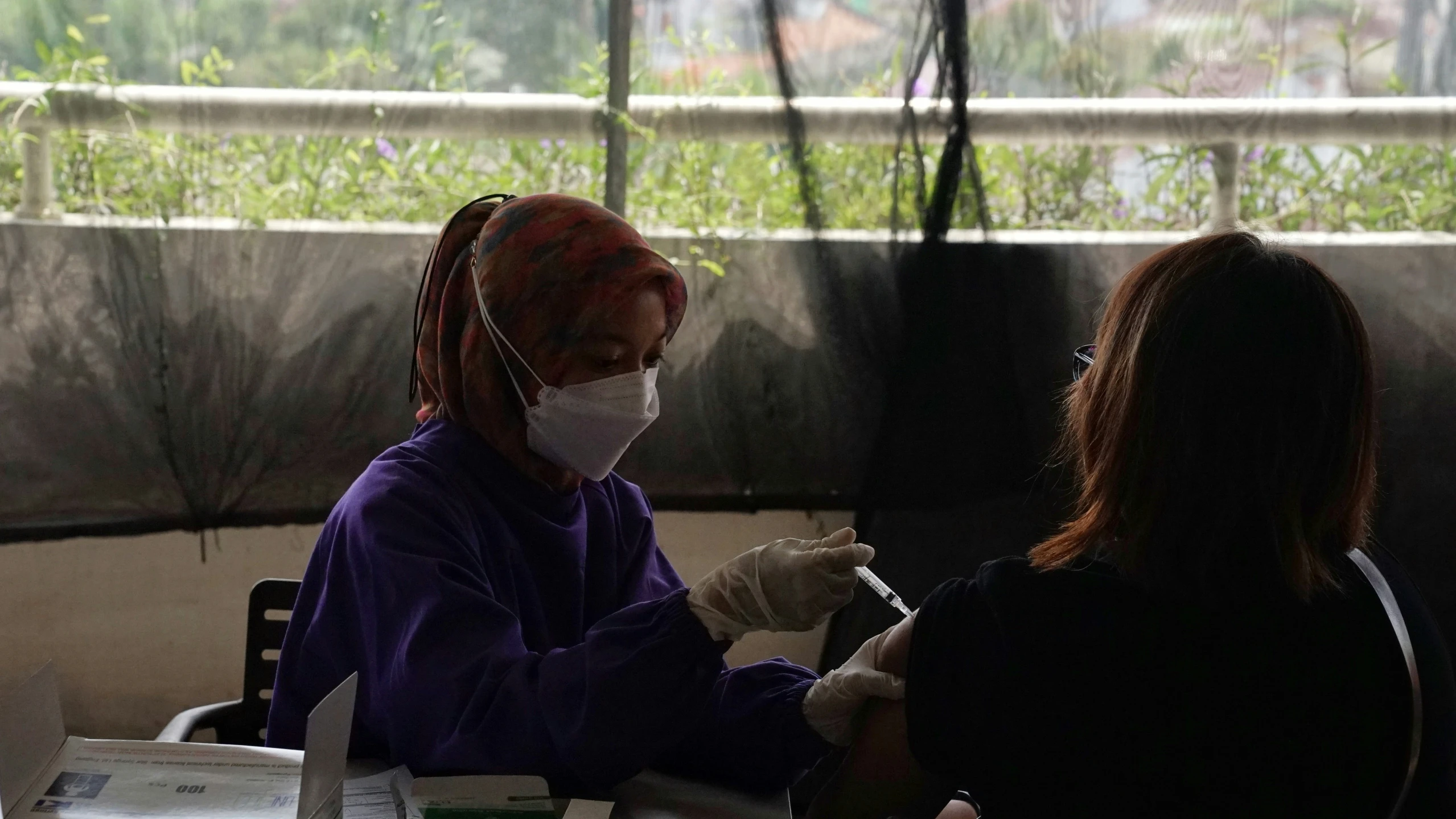 a man getting his teeth brushed by a woman