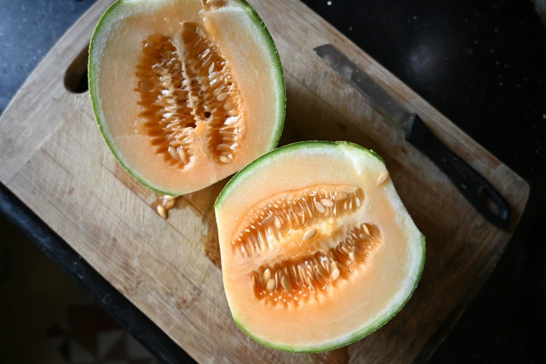 slices of watermelon sit on a  board