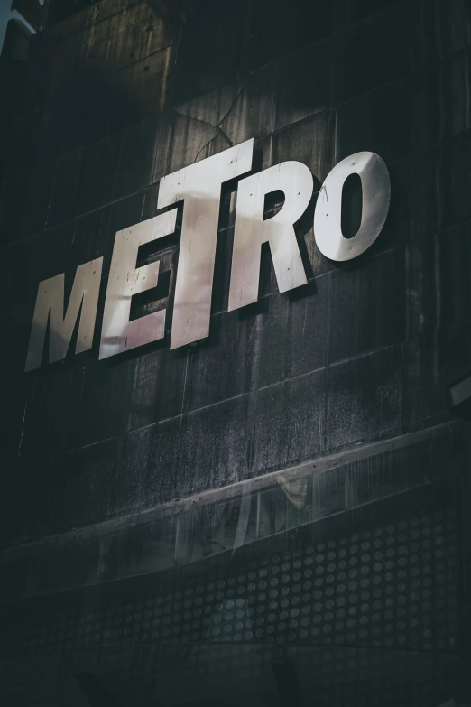 a building with a neon sign that says metro