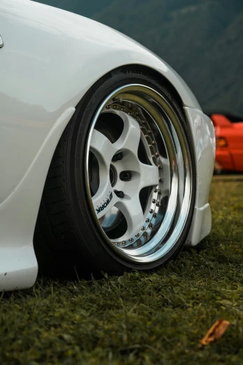 the rims on a white sports car on a grassy field