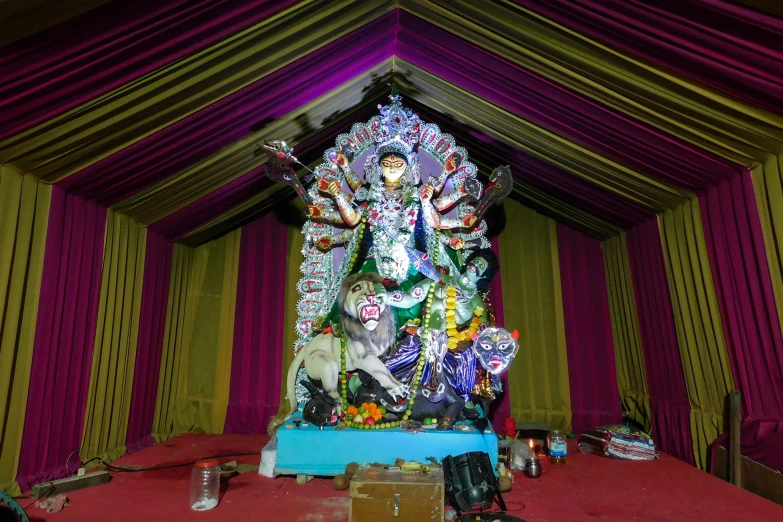 a very large and colorful statue in the corner of a room