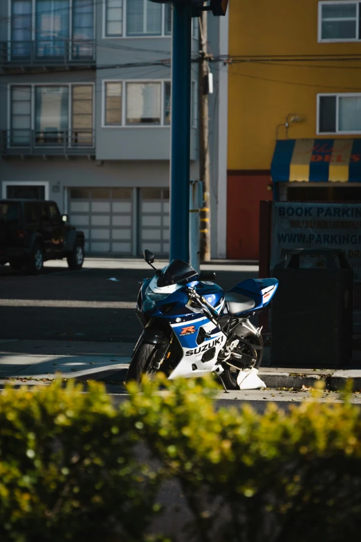 a blue and black motorcycle parked on the curb
