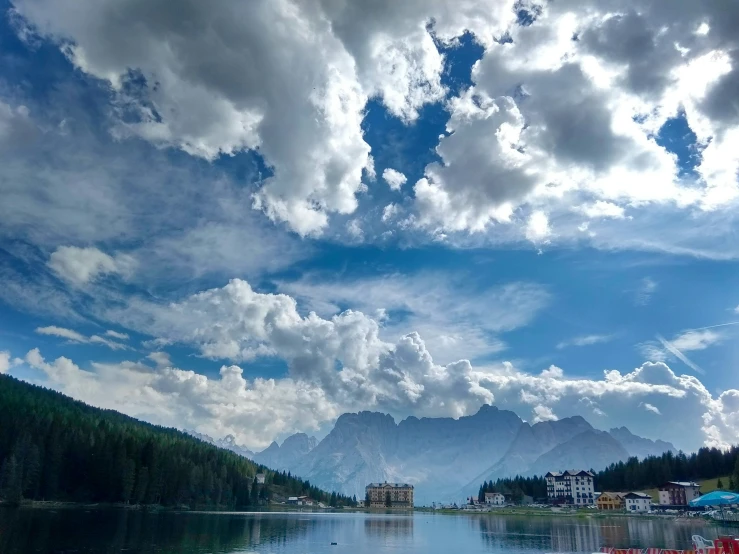 a boat in a lake with mountains in the background