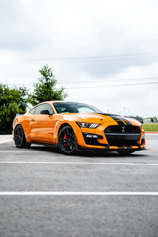 the orange sports car has a lowered hood