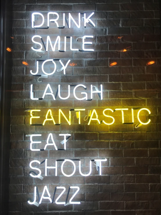 a neon sign saying drink smile joy laugh laugh laugh laugh laugh laugh laugh laugh laugh laugh laugh laugh laugh laugh laugh