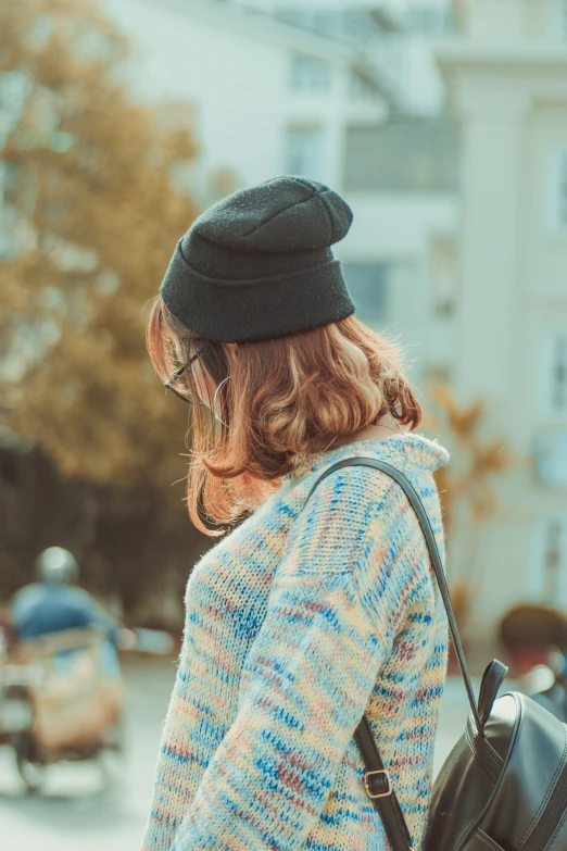 a  standing on the street looking down