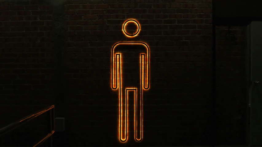 a male symbol with one foot and a hat is glowing in the dark