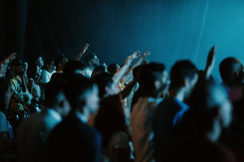 a group of people on stage waving and talking