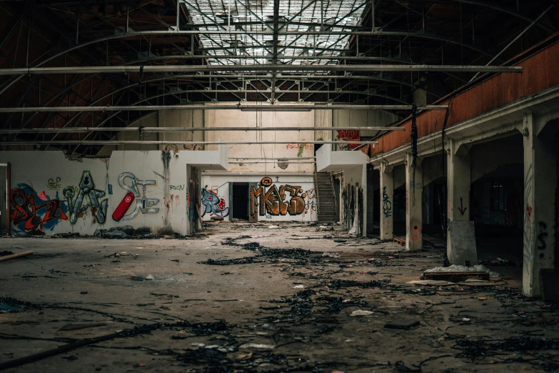 an empty area with graffiti, walls, and windows