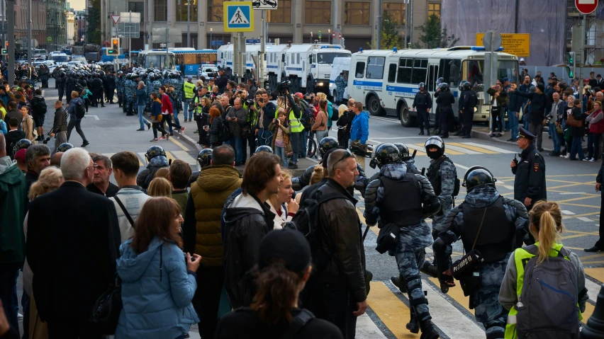 a crowd of people standing on top of a road