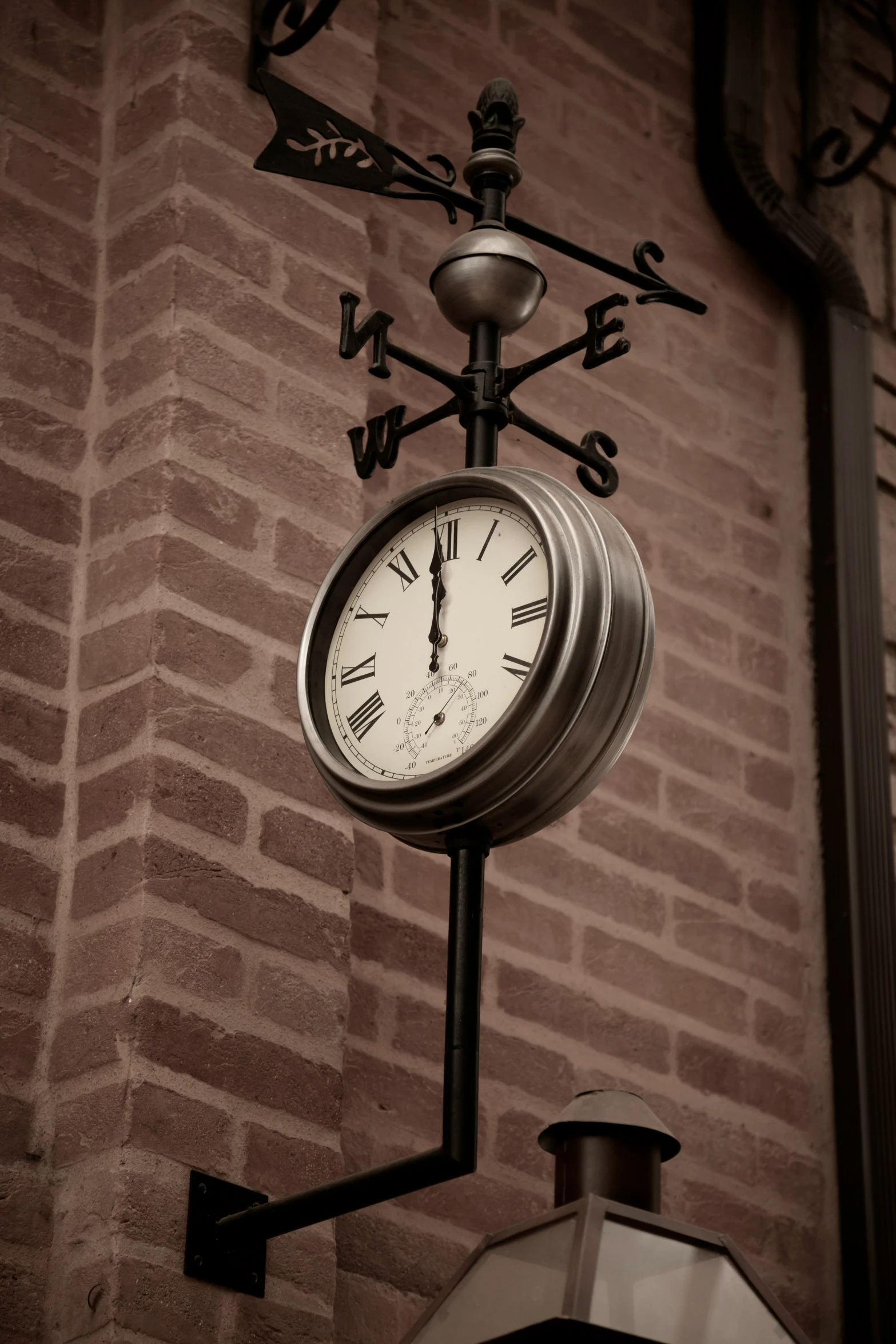 a clock is attached to the wall of a building