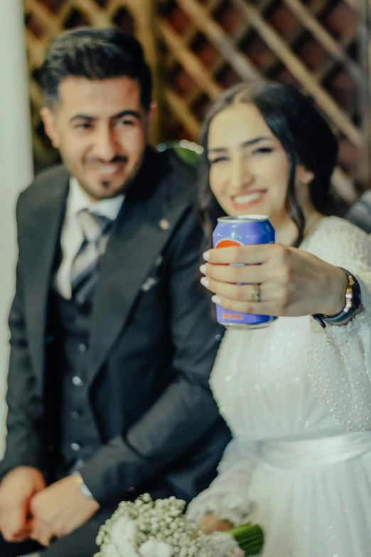 a couple are smiling while holding drinks